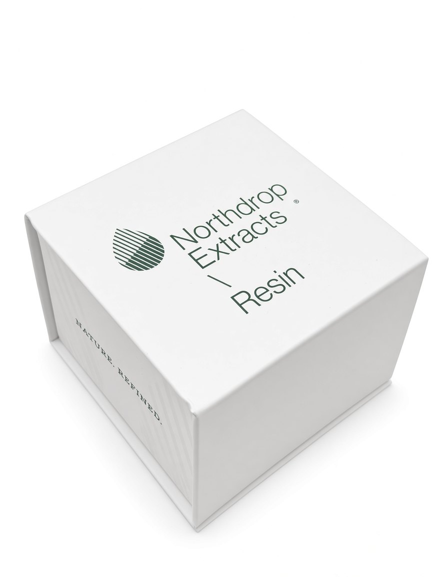 Northdrop Extracts Resin in an open glass jar beside the printed Nature. Refined. card